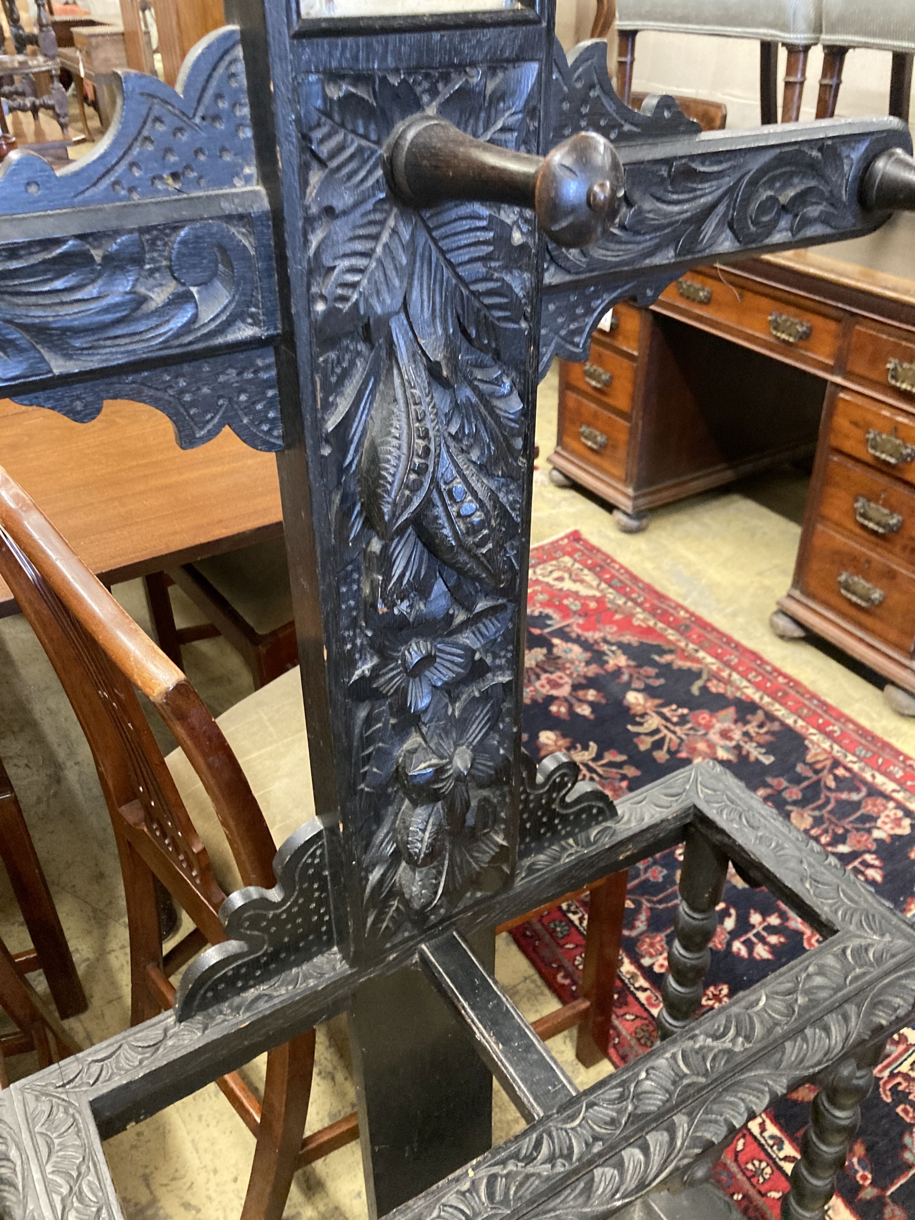 An early 20th century Flemish carved oak hall stand, width 60cm, depth 25cm, height 208cm